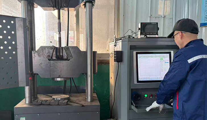 worker operating CNC machine rebar coupler production